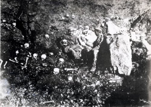 Soldiers holding skulls. ||| Wikimedia Commons