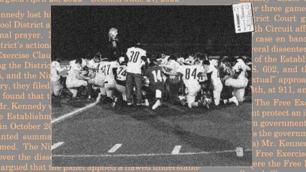 Football players praying on field