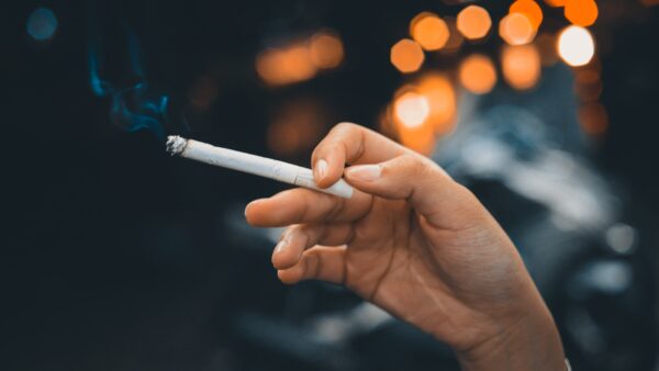 hand holding a smoking cigarette