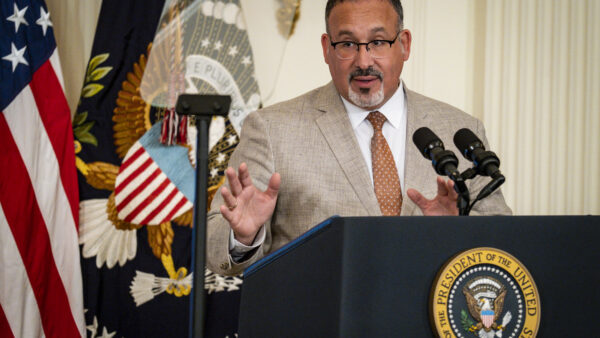 Education Secretary Miguel Cardona speaking at a press conference
