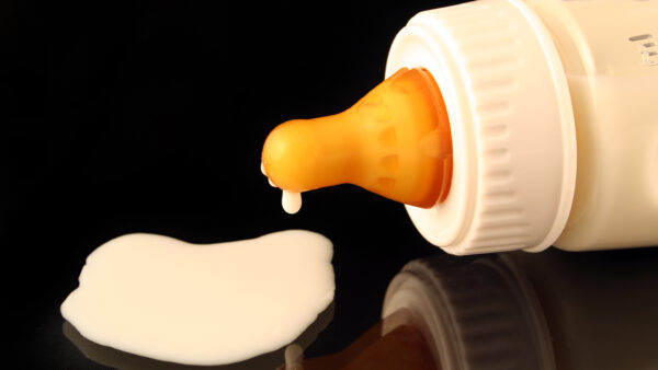 spilled baby formula coming out of a baby bottle