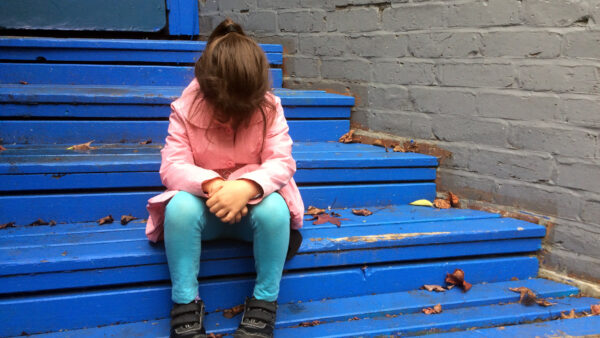 Kid on steps looking dejected
