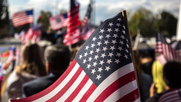 crowd of people waving American flags