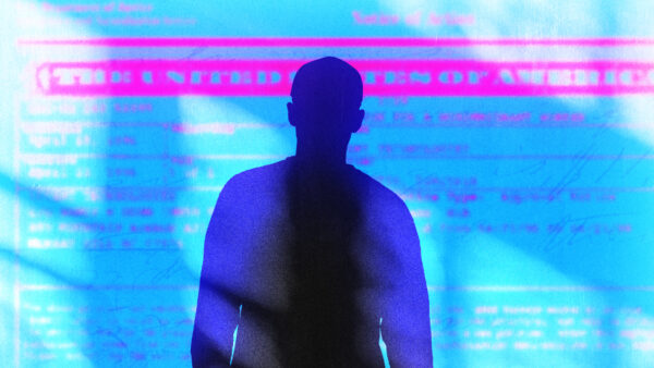 A man's silhouette in front of a U.S. visa