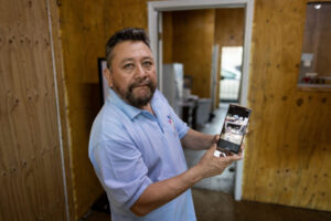 Carlos Pena in his shop, which was destroyed by a SWAT team