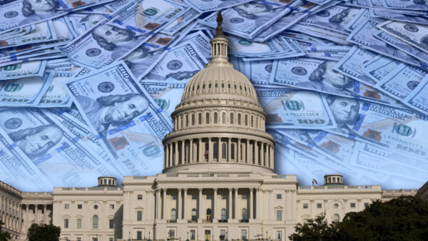 The U.S. Capitol is seen with money in the background