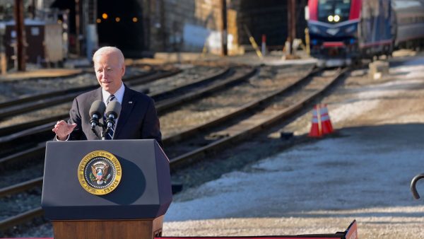 President Joe Biden giving a speech in front of a train