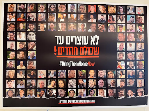 A poster of the hostages in Gaza reads, "#BringThem HomeNow"