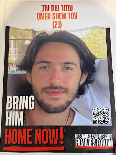 A poster of a young hostage, Omer, that reads "Bring him home now!" | Photo: Nancy Rommelmann