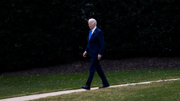 President Joe Biden walks a path from the Oval Office on the South Lawn of the White House.
