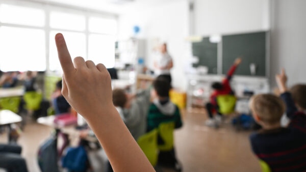 Pupils at an elementary school work on math problems in a classroom.