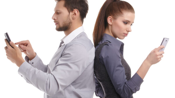 Two persons too busy with their mobile phones