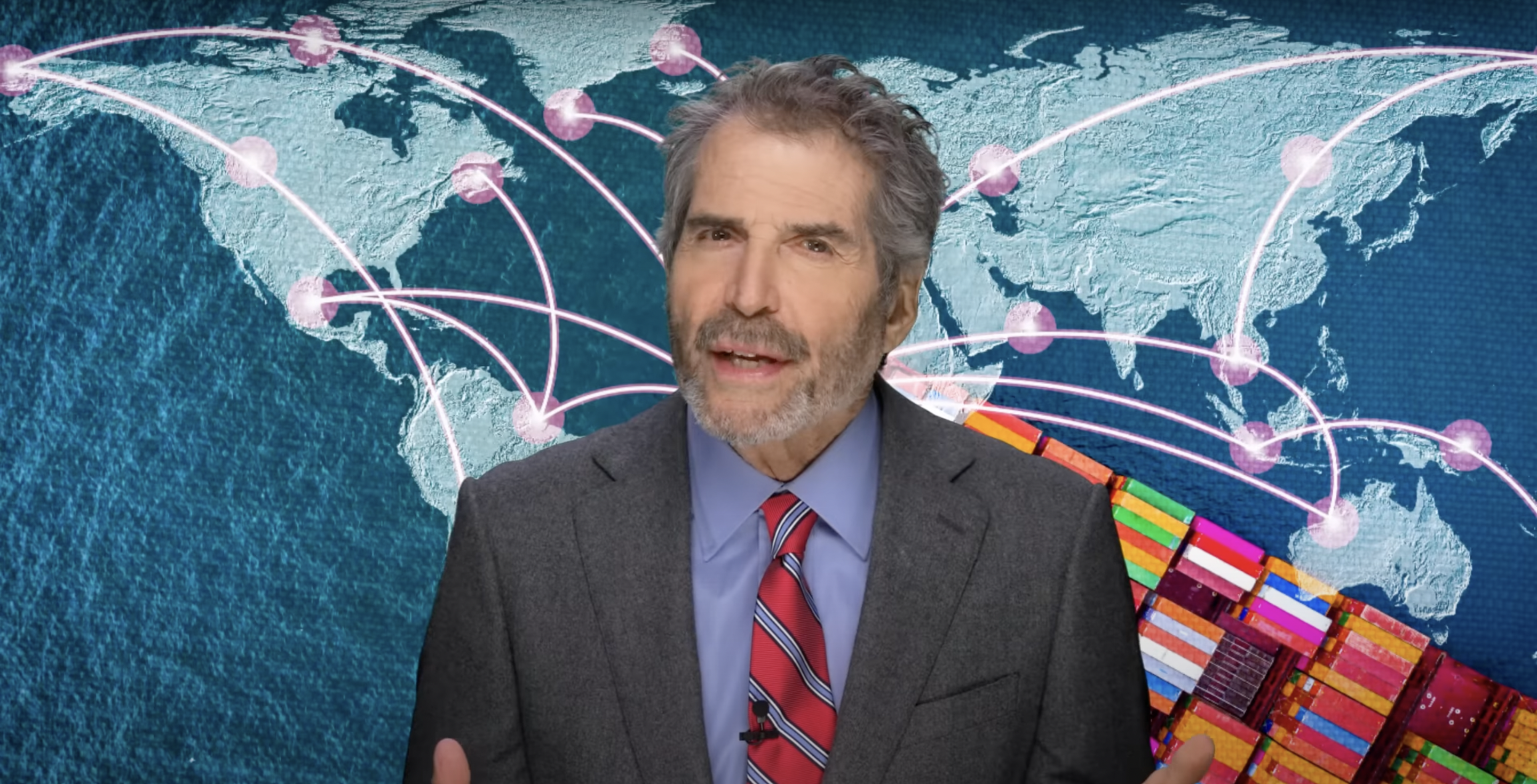 John Stossel stands in front of a map of the world