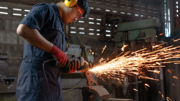 A man works in manufacturing at a factory