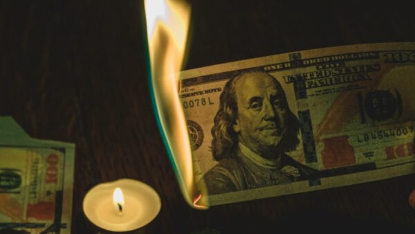a hundred dollar bill, lit on fire