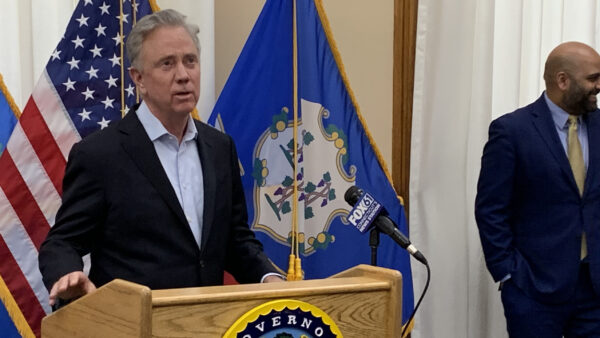 Connecticut Gov. Lamont stands behind a podium