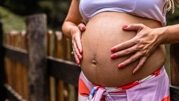A pregnant woman holding her stomach