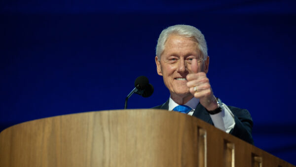 Former President Bill Clinton gives a thumbs up while speaking at the 2024 Democratic National Convention.