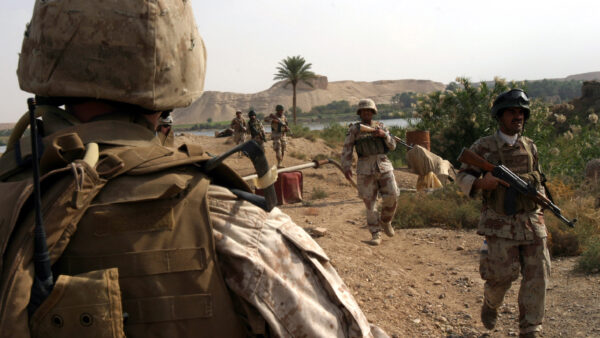 Iraqi soldiers and U.S. Marines conduct a foot patrol in Haditha, Iraq, Oct. 31, 2006.