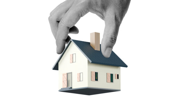 A hand holding a house