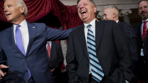 Sen. Lindsey Graham, R-S.C., right, shares a laugh with Vice President Joe Biden after a mock swearing-in ceremony for Sen. Tim Scott, R-S.C., in the Capitol's Old Senate Chamber, December 2, 2014.