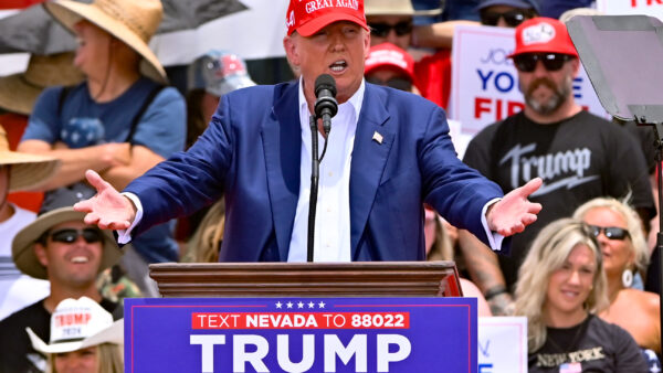 Donald Trump campaigning on stage and speaking to supporters