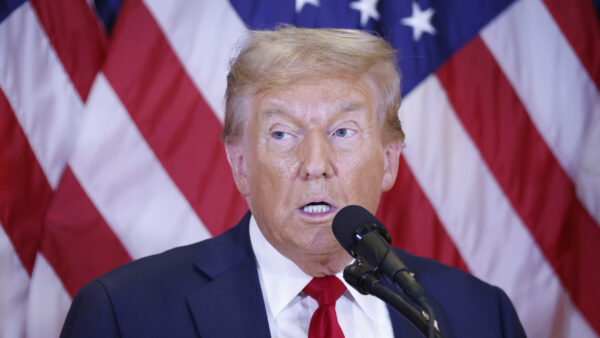 Former President Donald Trump speaking in front of the American flag