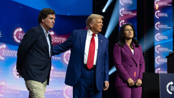 Donald Trump greets Tucker Carlson and Tulsi Gabbard at a rally in Duluth, Georgia. October 23, 2024.