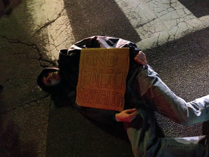 A #DCFerguson protester shuts down a street near the White House